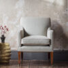 Bespoke, handmade armchair in linen with leather piping - Beaumont & Fletcher