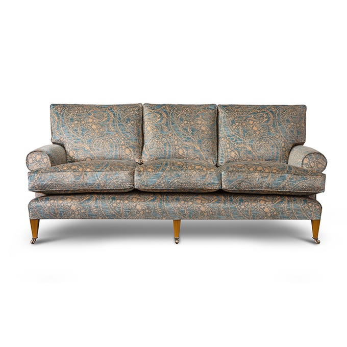 A luxury, bespoke sofa upholstered in a printed velvet fabric.