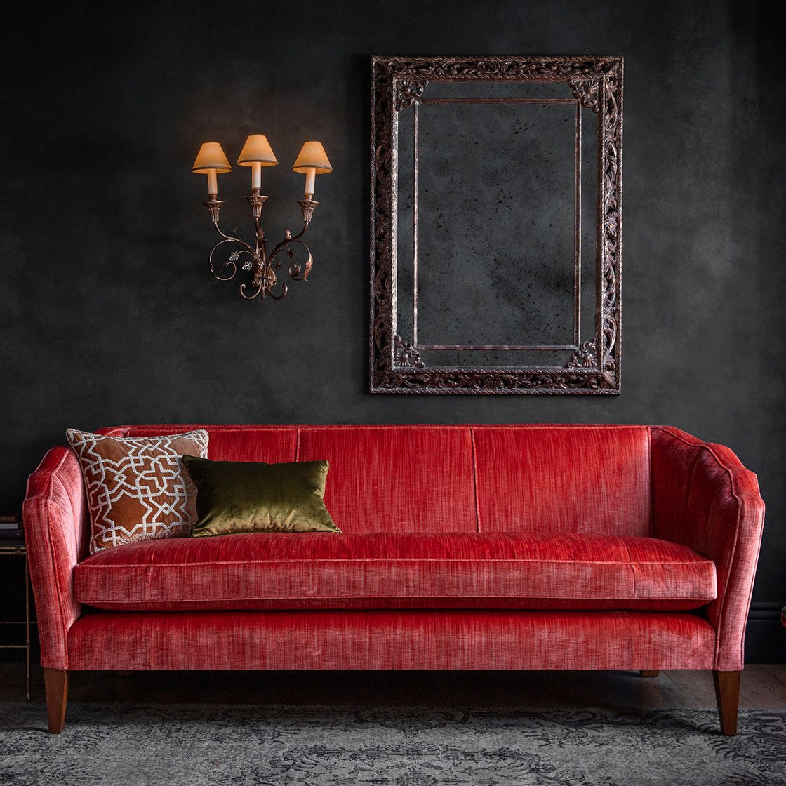 Josephine sofa in Como silk velvet - Pompeiian Red with Pisa wall light and Buckingham mirror with Habibi cushion - Beaumont & Fletcher