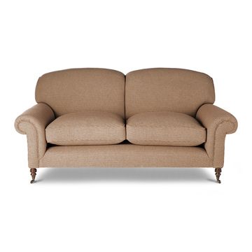 A luxury, bespoke sofa upholstered in a beige linen.