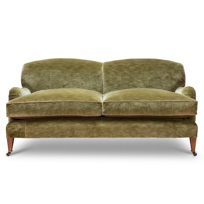 A luxurious, bespoke sofa in a contemporary green velvet.