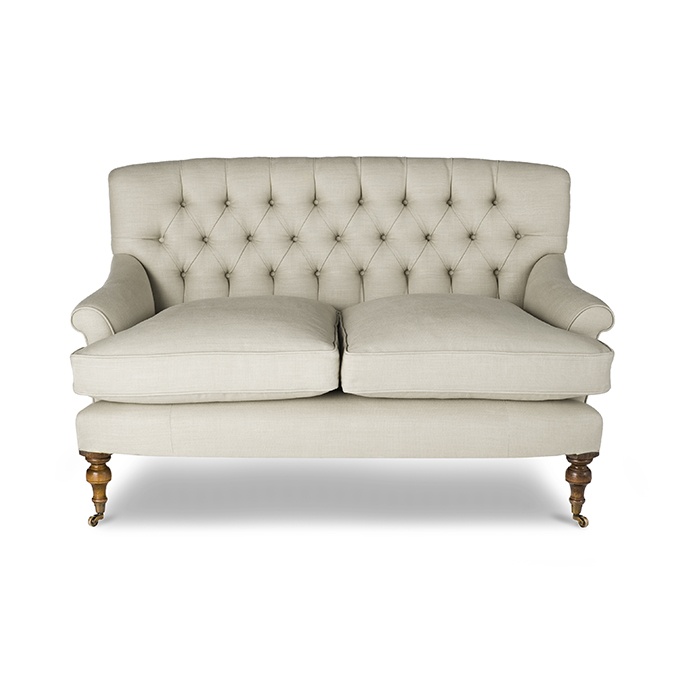 A luxury, bespoke sofa in a classic style with a deep buttoned back.