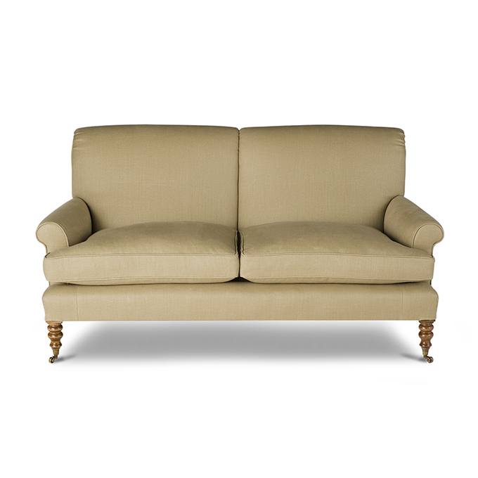 A luxury, bespoke sofa upholstered in a pale cream linen.