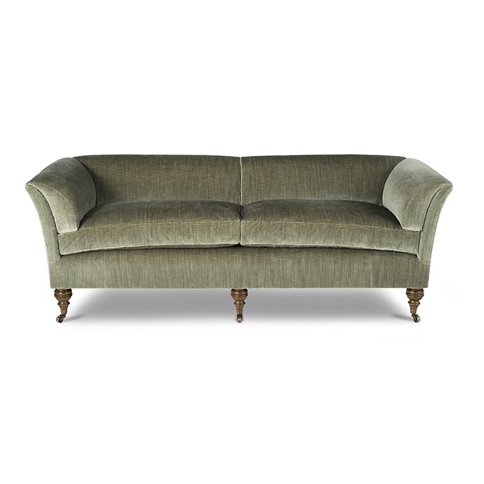 A luxury, bespoke sofa upholstered in a pale green silk velvet.