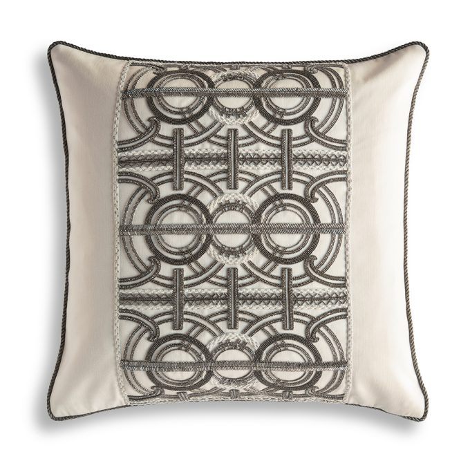 A hand embroidered designer cushion in cream wool with an art deco pattern