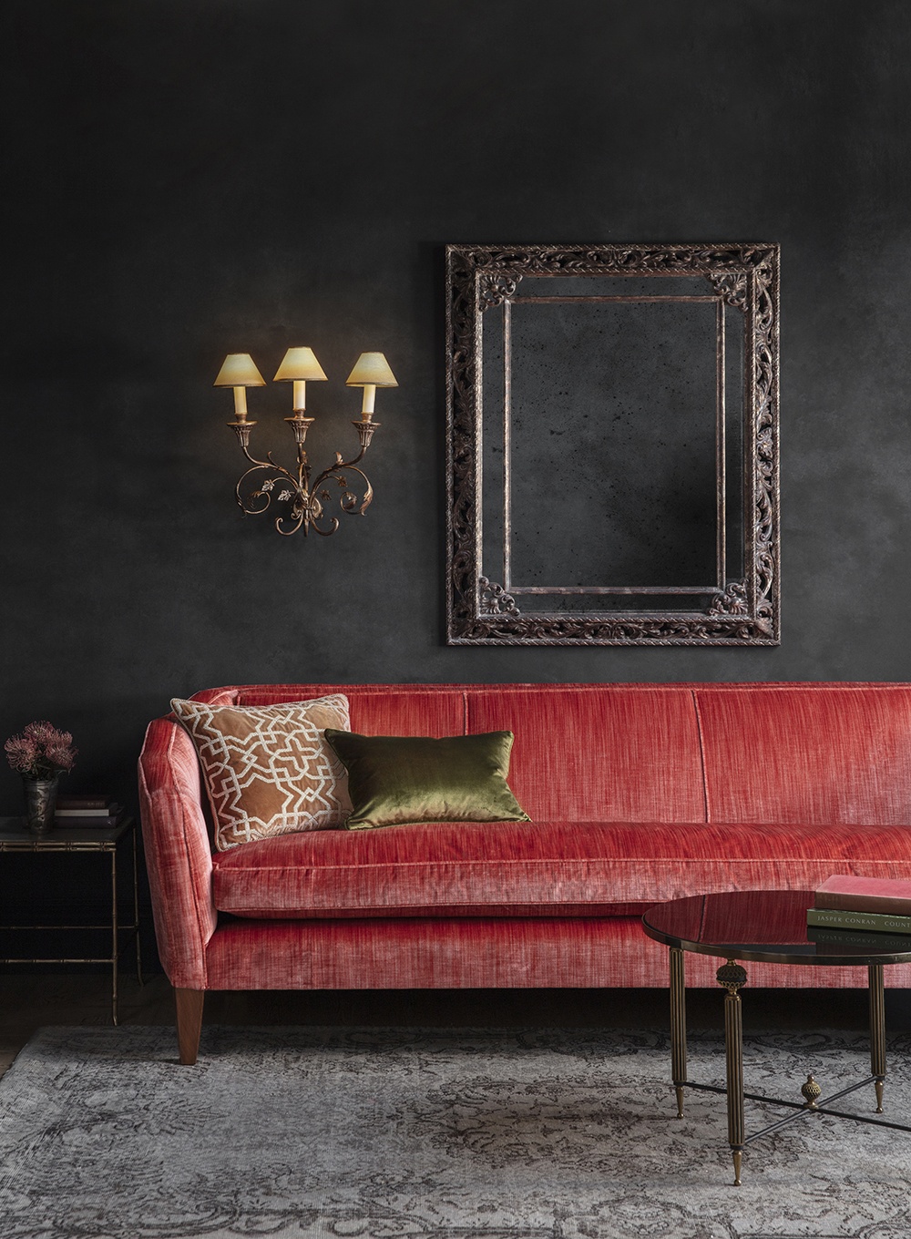 Habibi cushion in Capri - Copper on Josephine sofa in Como - Pompeiian Red with Pisa wall light and Buckingham mirror