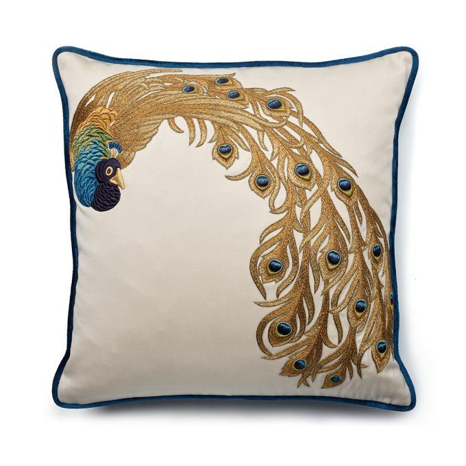 A hand embroidered designer cushion with a peacock on the front