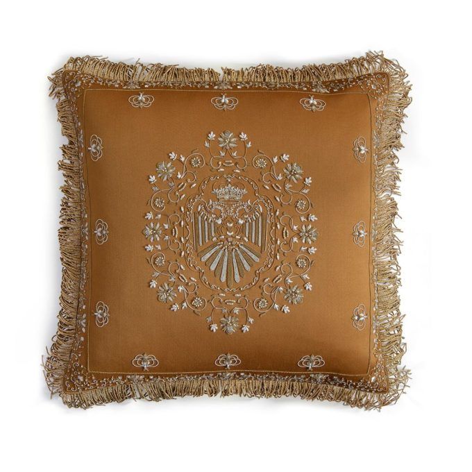 A hand embroidered designer cushion in a saffron coloured wool
