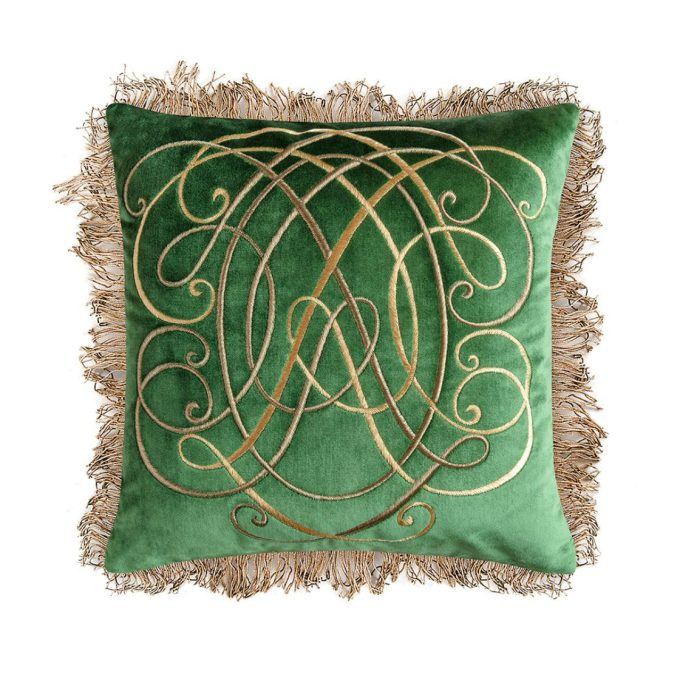 A hand embroidered designer cushion with an ornate design in green silk velvet