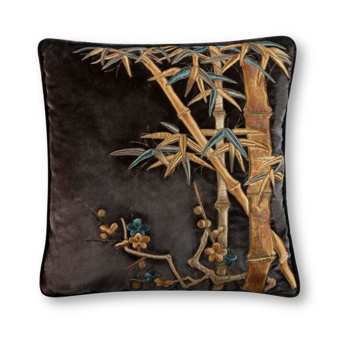 A hand embroidered designer cushion in purple silk velvet with a bamboo design