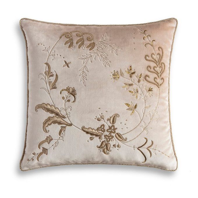 A hand embroidered designer cushion on a pale pink silk velvet