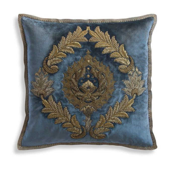 A hand embroidered designer cushion in silk velvet with an opulent pattern