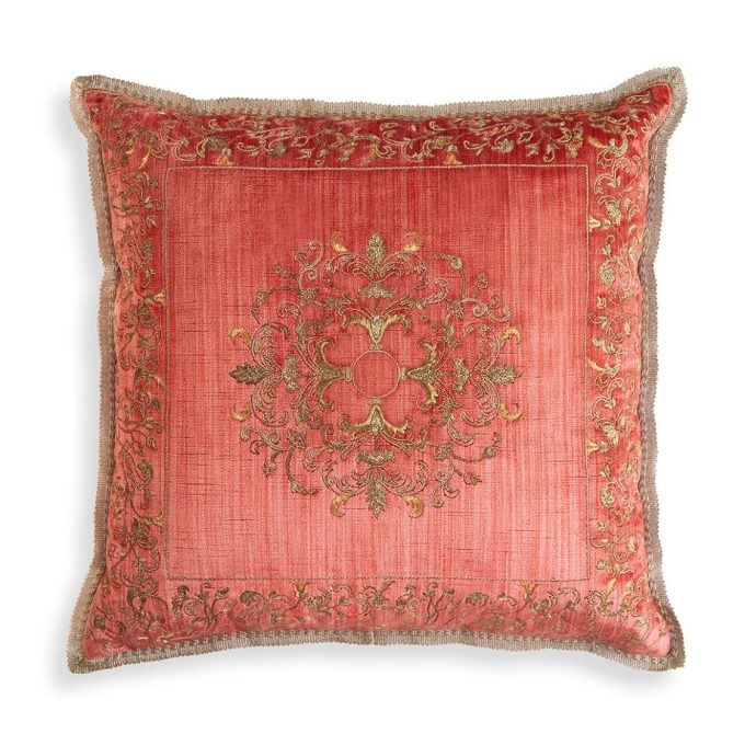 A hand embroidered designer cushion in red silk velvet