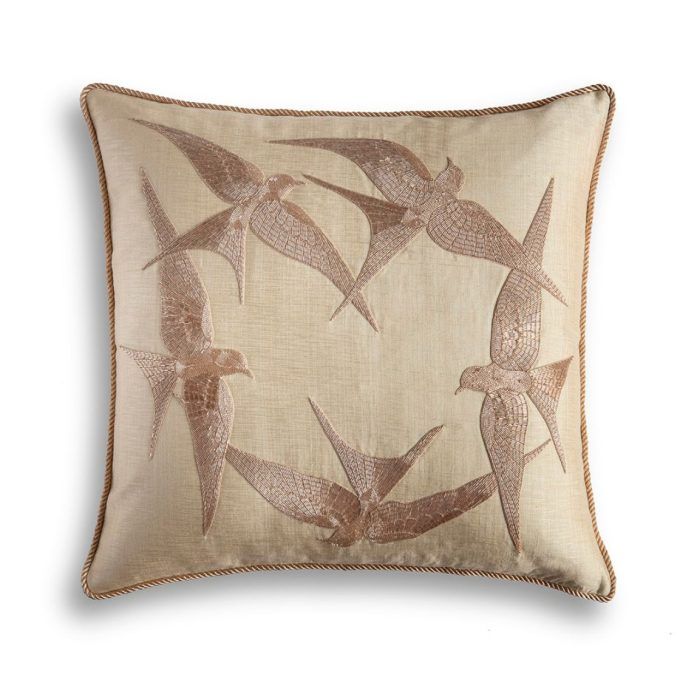 A luxury designer cushion with a hand embroidered circle of birds on the front