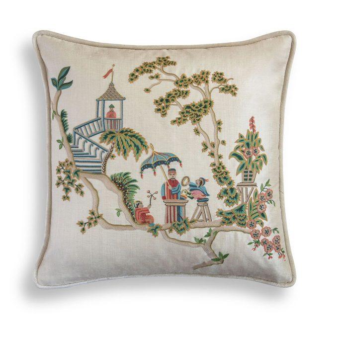 A hand embroidered designer cushion with a chinoiserie inspired design on the front