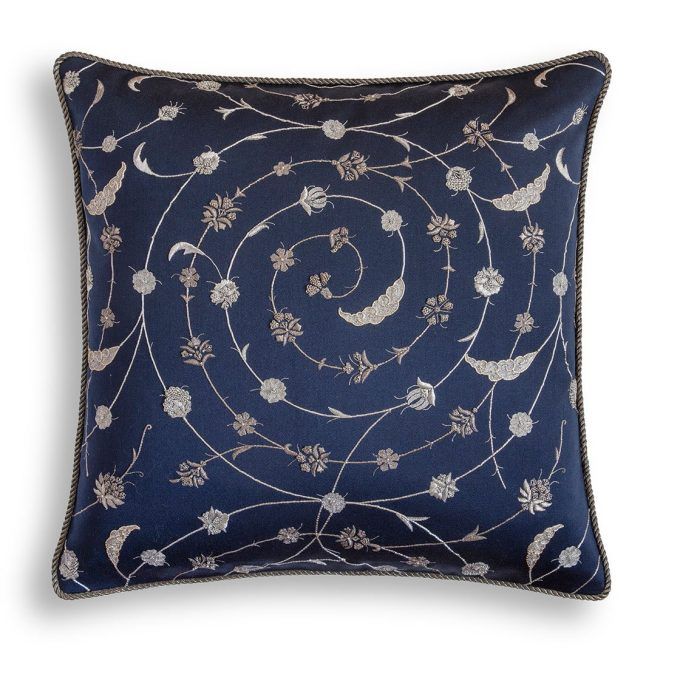A hand embroidered designer cushion in blue wool with a floral pattern