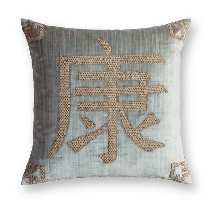 A hand embroidered designer cushion on silk velvet with a feng chinese pattern