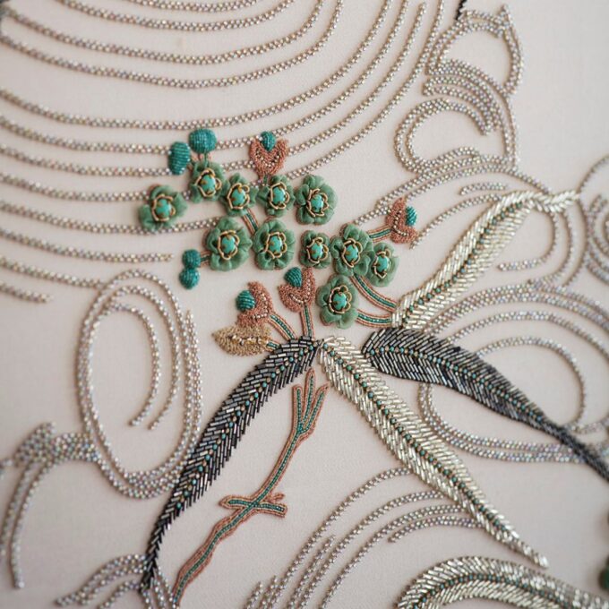 1930's inspired, hand embroidered design on cream wool drapes.