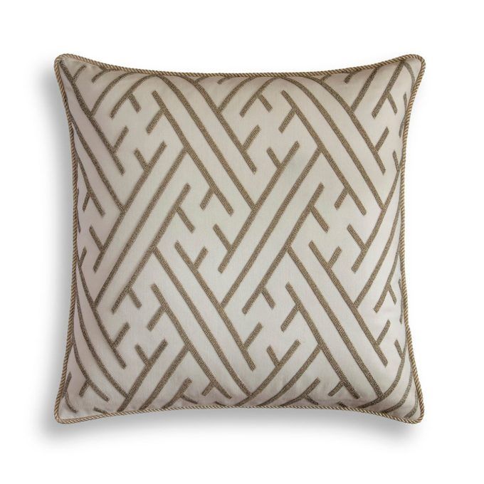 A hand embroidered designer cushion in a cream wool