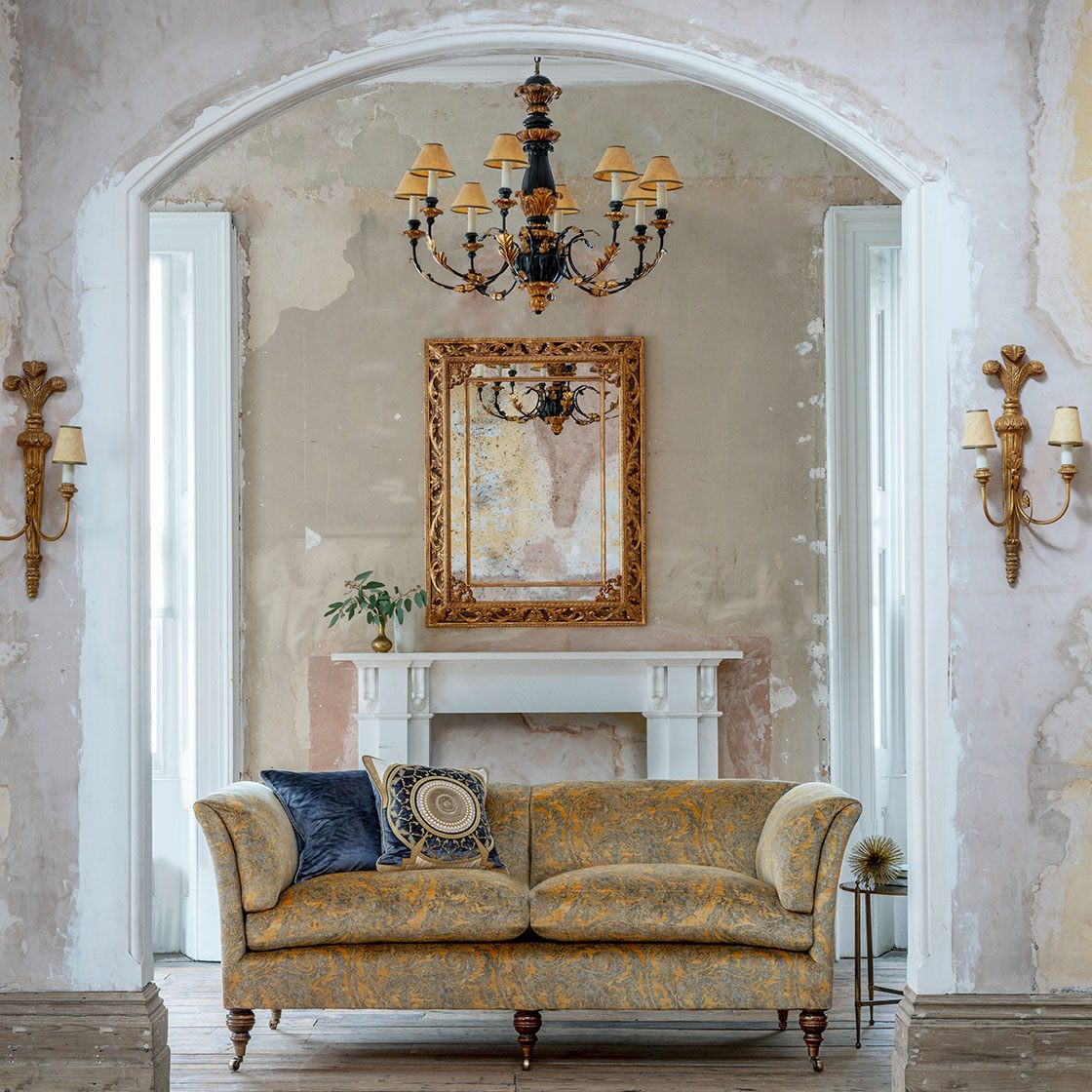 Buckingham mirror in Distressed gold with Pompadour sofa, Ettore cushions Windsor lights and Chatsworth chandelier - Beaumont & Fletcher
