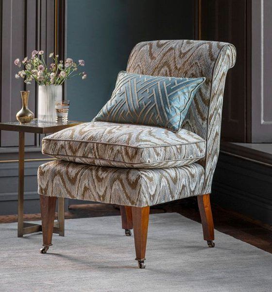 Accent armchair upholstered in a bold flame stitch fabric in tones of blue and green