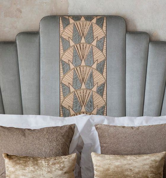 A headboard embellished with an Art Deco inspired hand embroidery design in the middle panel