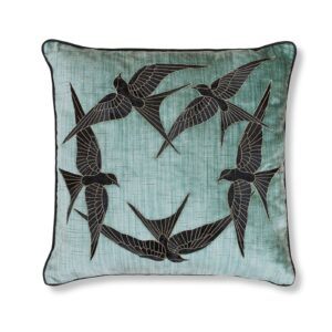 A blue silk velvet cushion with a hand embroidered circle of birds on the front