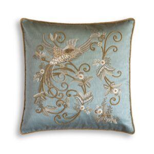 A luxurious blue silk cushion with a hand embroidered bird of paradise on the front